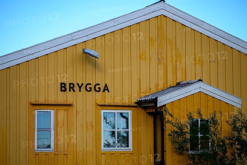 Yellow wooden building with simple, clear architecture, A yellow wooden building with two windows and Scandinavian design, Nordfjord, Båtsfjord, Finnmark, Norway