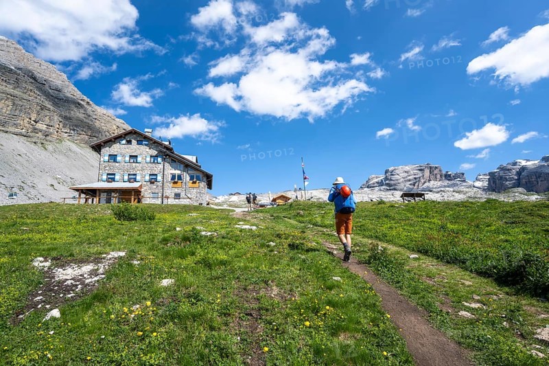 Hikers in front of Rifugio Graffer, Brenta, Brenta-Adamello Natural Park, Trentino, Italy