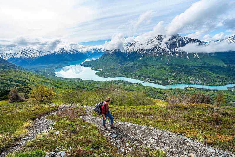 Climbers on a hiking trail, Slaughter Ridge Trail, view of snowy mountains and turquoise lake Kenai Lake, Cooper Landing, Kenai Peninsula, Alaska, USA