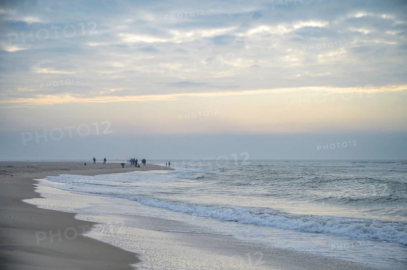 People stroll along the beach in a calm evening mood, Texel island, Noord Holland, the Netherlands