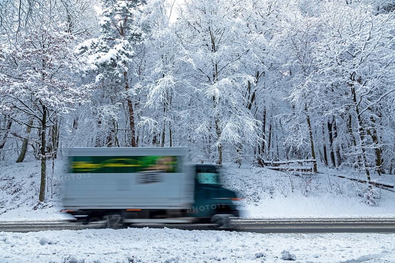 Delivery truck drives through snowy landscape, trees, winter, snow, Sieversen, Samtgemeinde Rosengarten, Lower Saxony, Germany
