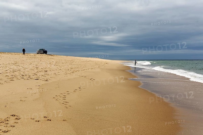 Ocean walkers, fall cloud cover, SUV on horizon, offroad, Provincetown, Race Point Beach, Cape Cod National Seashore, Atlantic Coast, Massachusetts, New England, USA