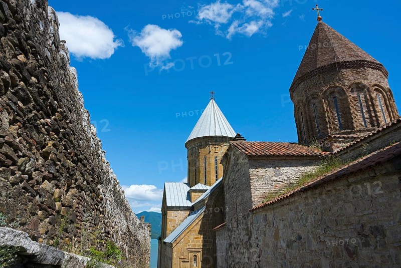Historic monastery complex with brick towers and a surrounding stone wall under a blue sky, Ananuri Castle, Zhinvali Reservoir, Jinvali or Shinvali, Mtskheta-Mtianeti Region, Georgian Military Road, Georgia
