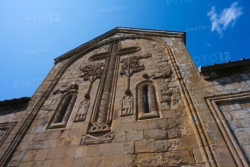 Historic church façade with large cross reliefs and decorations under a blue sky, Ananuri Castle, Zhinvali Reservoir, Jinvali or Shinvali, Mtskheta-Mtianeti Region, Georgian Military Highway, Georgia