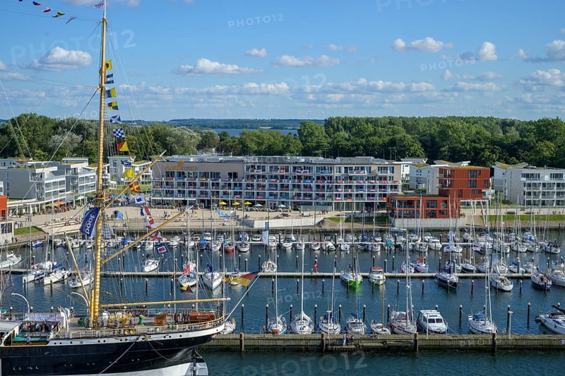 Harbour view with the legendary four-masted PASSAT barque and many boats in front of modern buildings under blue skies, Travemünde, Lübeck, Schleswig-Holstein, Germany
