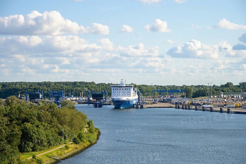 Scandinavienkai Tavemünde with large Finnlines ferry in port, surrounded by water and fluffy clouds, Travemünde, Lübeck, Schleswig-Holstein, Germany