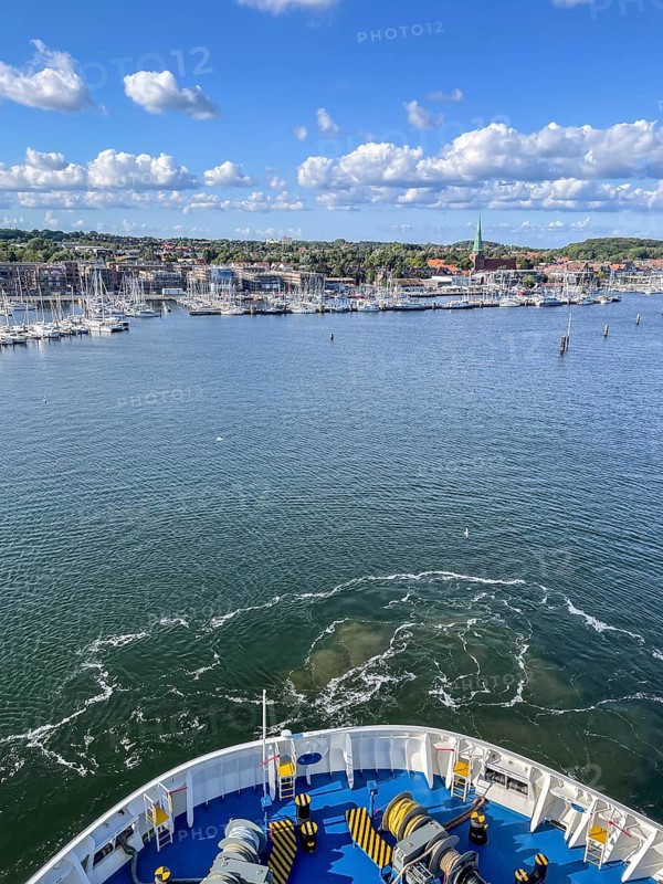 View from a ship's hull across the water towards the harbor entrance, Travemünde, Lübeck, Schleswig-Holstein, Germany