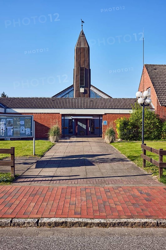 St. Ulrich Catholic Church, church tower, brick building material, entrance, display case, lantern, wooden fence, front garden, lawn, blue sky, cloudless, bathing alley, Sankt Peter-Ording, district of North Frisia, Schleswig-Holstein, Germany