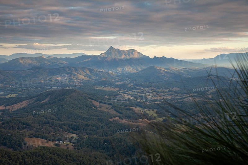 Sunset with an open view across the valley toward Mount Warning (Wollumbin), captured from the summit of Mount Cougal, highlighting natural depth and wide landscape perspective, Queensland and New South Wales, Australia