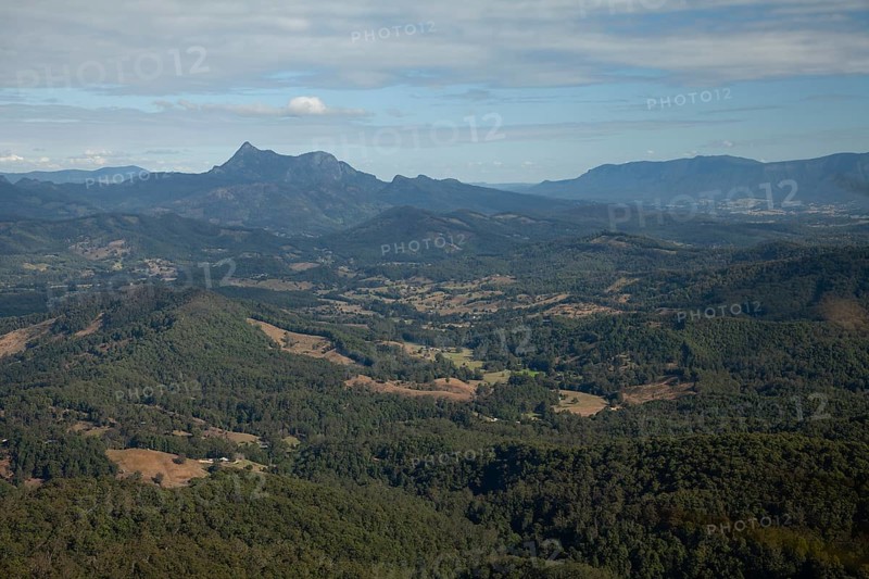 Clear blue sky with an open view across the valley toward Mount Warning (Wollumbin), captured from the summit of Mount Cougal, highlighting natural depth and wide landscape perspective, Queensland and New South Wales, Australia