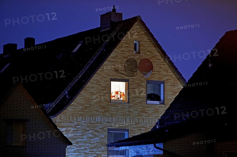 Illuminated window of a residential building in a settlement at night, Witten, Ruhr region, North Rhine-Westphalia, Germany