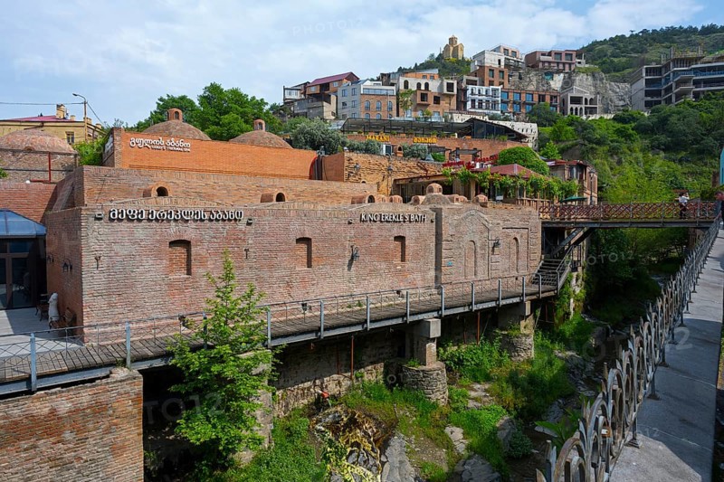 River valley with a brick bridge surrounded by historic architecture, King Erekles Bath, Abanotubani Spa District, Old Town, Tbilisi, Tbilisi, Georgia