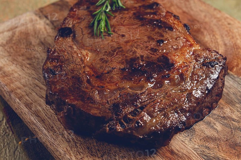 Grilled steak, beef steak, rib eye steak, on a chopping board, top view, no people