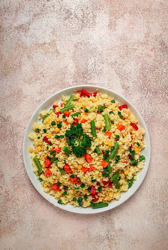 Couscous with vegetables, paprika, carrots, string beans, corn, homemade, top view, no people