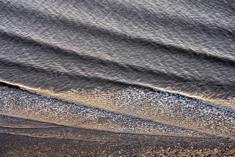 Small waves run on the beach