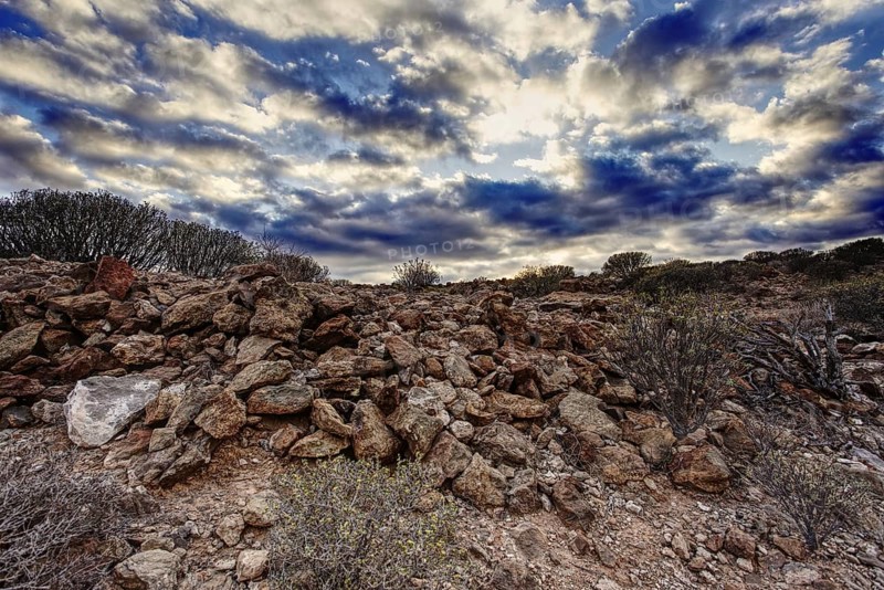 Rocky volcanic landscape under a dramatic and cloudy sky, Los Cristianos Tenerife
