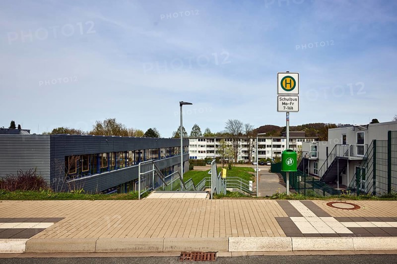 School bus stop, Hauptschule Mathilde - Anneke - school, houses, modern buildings, apartment buildings, residential buildings, lantern, trees, meadow, diffuse light, milky blue sky, cirrostratus clouds, Dresdener Straße, Sprockhövel, Ennepe-Ruhr-Kreis, North Rhine-Westphalia, Germany