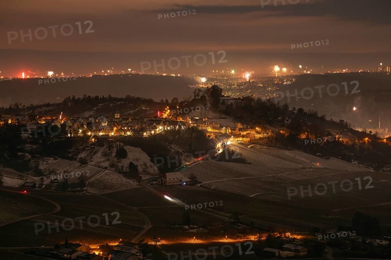 New Year's Eve view from Kapellberg near Fellbach towards Rotenberg. View of the grave chapel in Württemberg as fireworks rockets and firecrackers illuminate the night sky over Stuttgart on New Year's Eve from 2025 on 2026 at the turn of the year