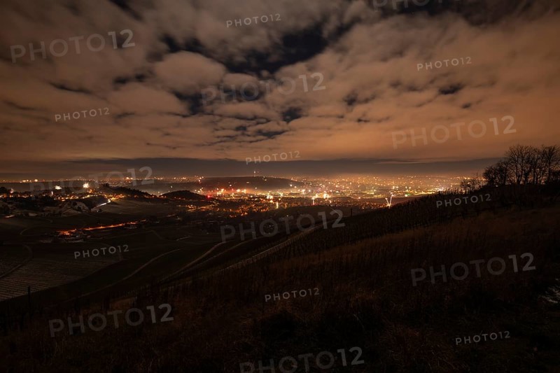 New Year's Eve view from Kapellberg near Fellbach towards Rotenberg Neckar Valley and Stuttgart. View of the grave chapel in Württemberg as fireworks rockets and firecrackers illuminate the night sky over Stuttgart on New Year's Eve from 2025 on 2026 at the turn of the year