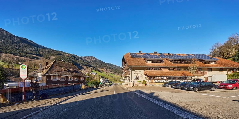 Gasthof Hotel Engel, Schwarzwaldhaus, general architecture, houses, Simonswald Engel bus stop, hills, hilly landscape, coniferous forest, parking with cars, road, blue sky, cloudless, intersection of Obertalstraße with Kilpensträssle, Simonswald, Black Forest, district of Emmendingen, Baden-Württemberg, Germany