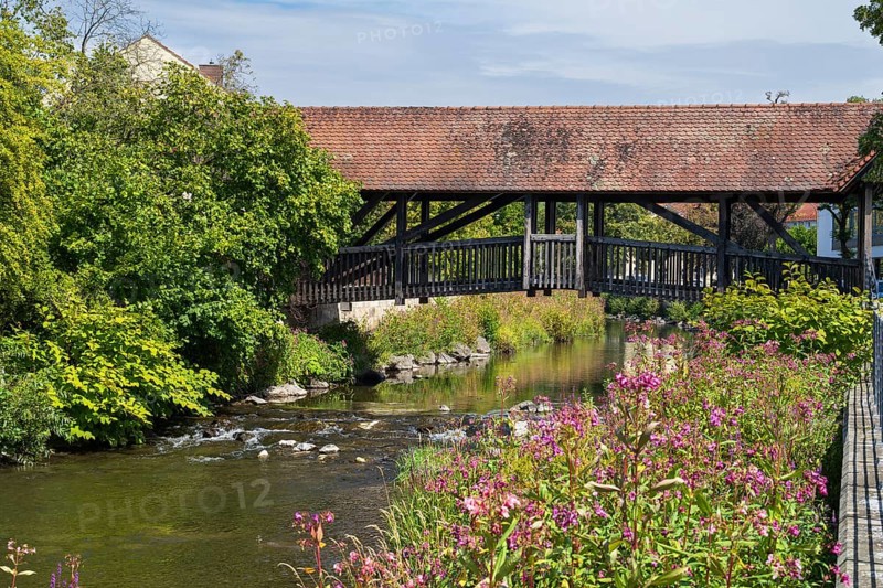 Covered footbridge over the Kronach river, hospital bridge, Blooming flowers on the shore, Kronach, Upper Franconia, Franconia, Bavaria, Germany