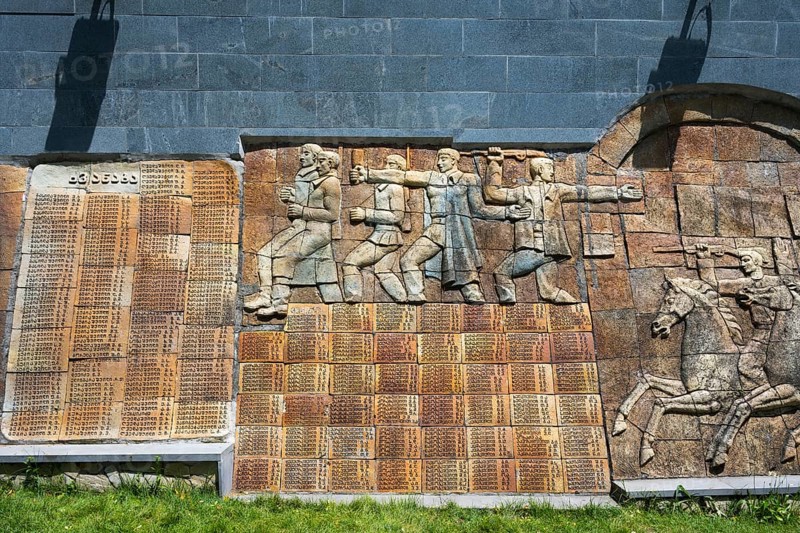 Stone relief with figures and memorial plaque in a historical illustration, commemoration of World War II, Sighnaghi, Signagi, Kakheti province, Greater Caucasus, Georgia, Near East Asia