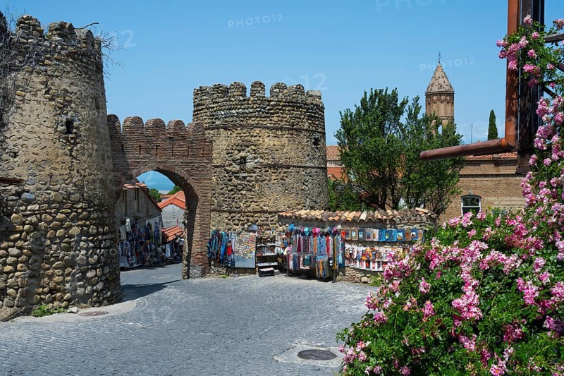 Historic stone gate with stalls and flowers in the foreground, city gate, entrance to the old town, Sighnaghi, Signagi, Kakheti province, Greater Caucasus, Georgia, Western Asia