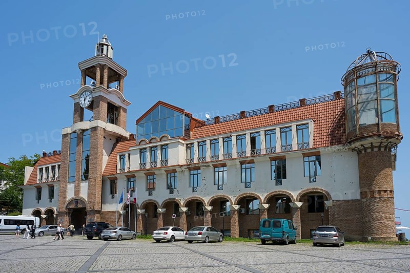 Historic building with clock tower and vehicles in the foreground under clear sky, City Hall, Sighnaghi, Signagi, Kakheti Province, Greater Caucasus, Georgia, Western Asia