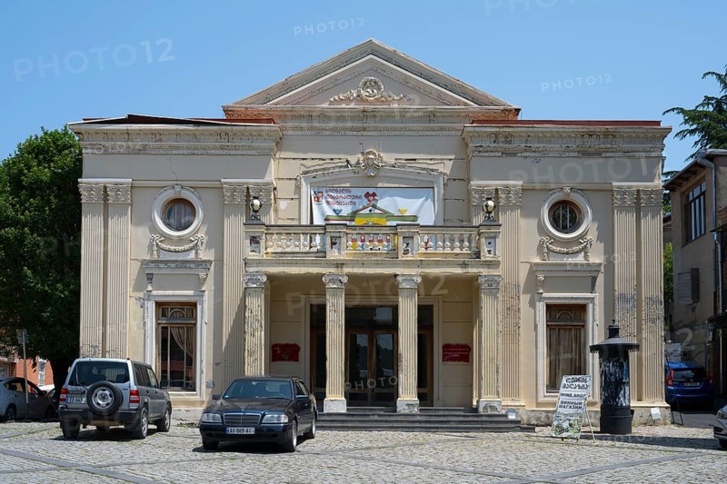 Neoclassical theatre building with columns and cars in the foreground on a sunny day, theatre, Sighnaghi, Signagi, Kakheti province, Greater Caucasus, Georgia, Western Asia