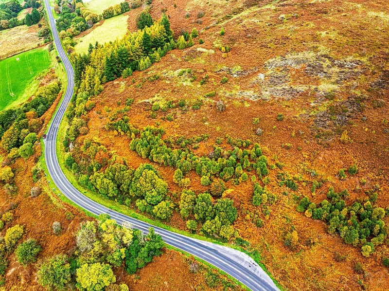 Autumn colours of Farms over River Wye and Road A470 from a drone, Llanidloes, Powys, Montgomeryshire, Wales, UK