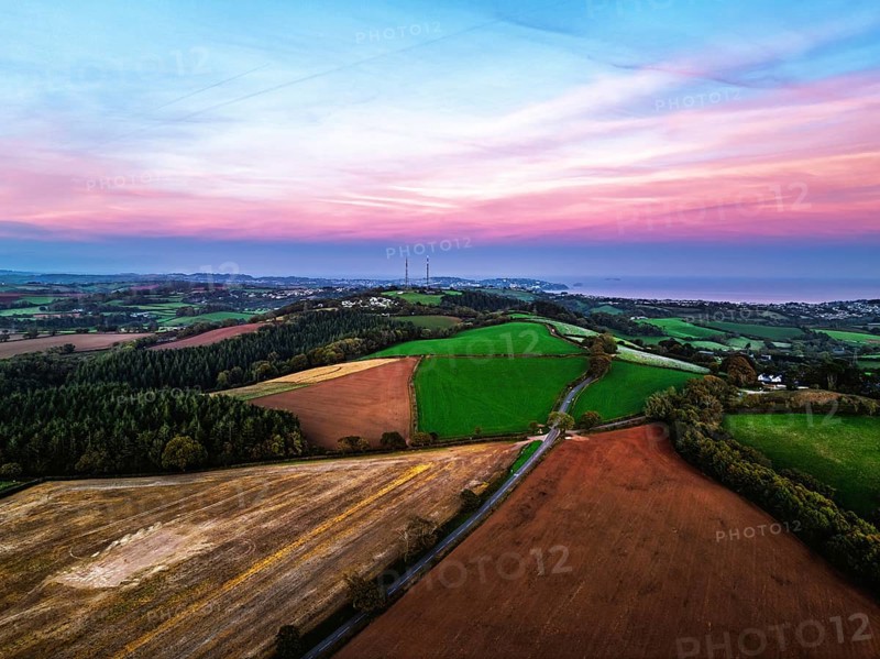 Sunset of Devon Farms and Fields over Berry Pomeroy from a drone, Totnes, England, United Kingdom