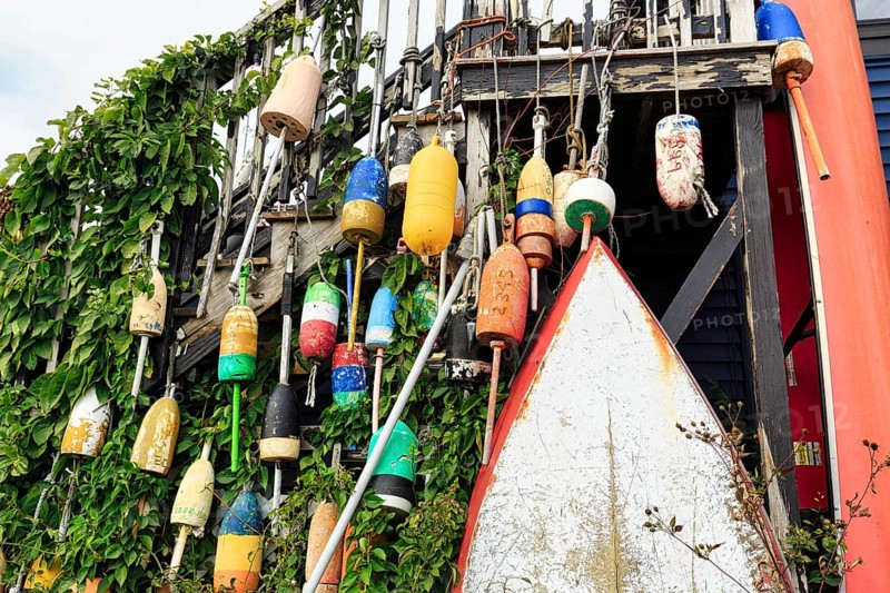 Colorful lobster buoys, boat, decoration, facade detail, seafood restaurant, lobster specialty, Perkins Cove, picturesque fishing village in Ogunquit, Maine, New England, USA