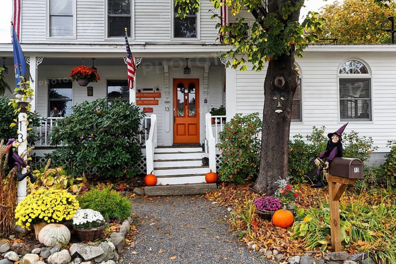 Typical American house in autumn, white wooden house with porch and front garden, guest room, booked out, decoration for Halloween, Ogunquit, Maine, New England, USA