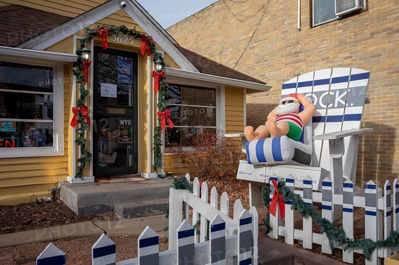 Arvada, Colorado - A blow-up Santa lounges in a beach chair outside a store in Olde Town Arvada as the temperature reached 70F on Christmas Eve