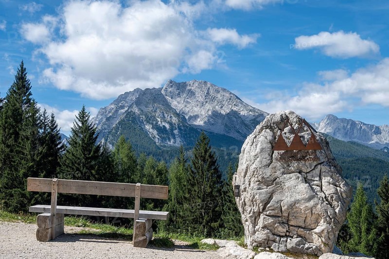 Bench and symbol of the Berchtesgaden National Park on its border, with the Watzmann in the background, Bavaria, Germany