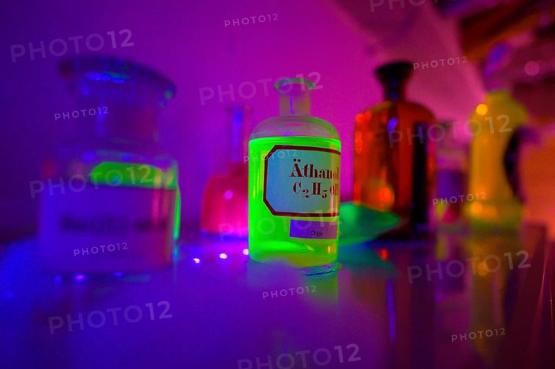 Glowing bottles in an escape room chemical laboratory with neon light create a mystical atmosphere, Lower Saxony, Germany