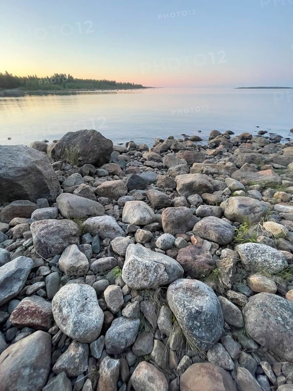 Midsummer on the Gulf of Bothnia at sunset with a stone shore, Ånäset, Västerbottens län, Sweden
