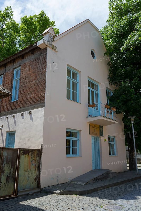 Two-storey building with bricks and blue door, surrounded by trees on a sunny day, Katharinenfeld administration building, restoration 2019-2021, Bolnissi, Katharinenfeld, founded by Caucasian German settlers, Lower Kartli region, Kwemo Kartli, Georgia