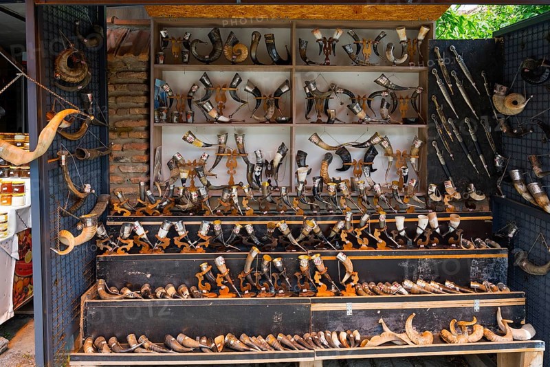Souvenir stand with a large collection of traditional horns displayed on wooden shelves, Mtskheta, Mtskheta, Mtskheta-Mtianeti region, Georgia