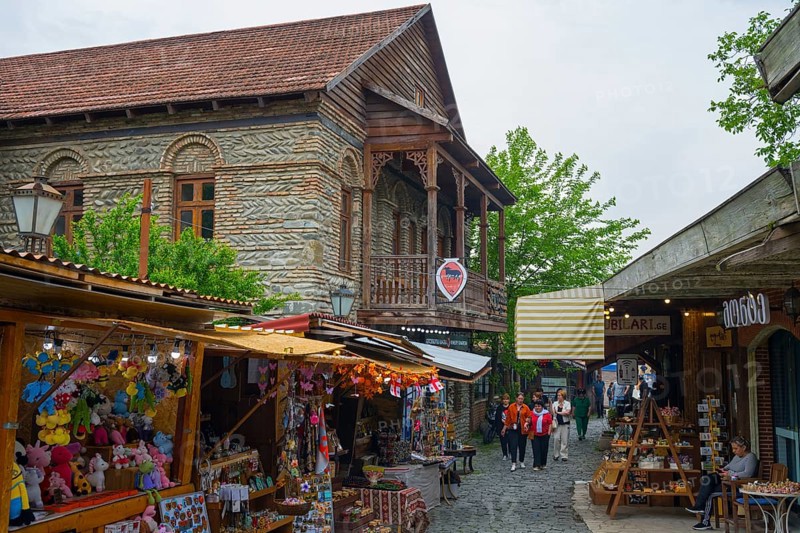 Busy old town street with traditional buildings and market stalls selling souvenirs, Mtskheta, Mtskheta, Mtskheta-Mtianeti region, Georgia