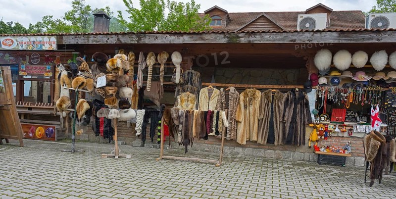Market stall with fur hats and coats surrounded by souvenirs and traditional style, Mtskheta, Mtskheta, Mtskheta, Mtskheta-Mtianeti region, Georgia