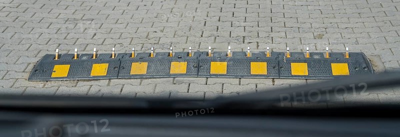 Ground obstruction with yellow markings on a paved road, one-way speed problems with spikes on the road, steel road spikes, destroys tires if you run over them from the wrong side, Mtskheta-Mtianeti region, Georgia
