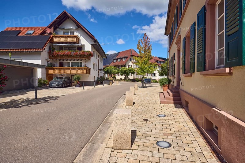 Black Forest house, building, general architecture, town hall, entrance, staircase, balcony, façade with windows and shutters, barrier bollard, sidewalk, street, trees, blue sky, cumulus clouds, main street, Hofstetten, Black Forest, Ortenaukreis, Baden-Württemberg, Germany