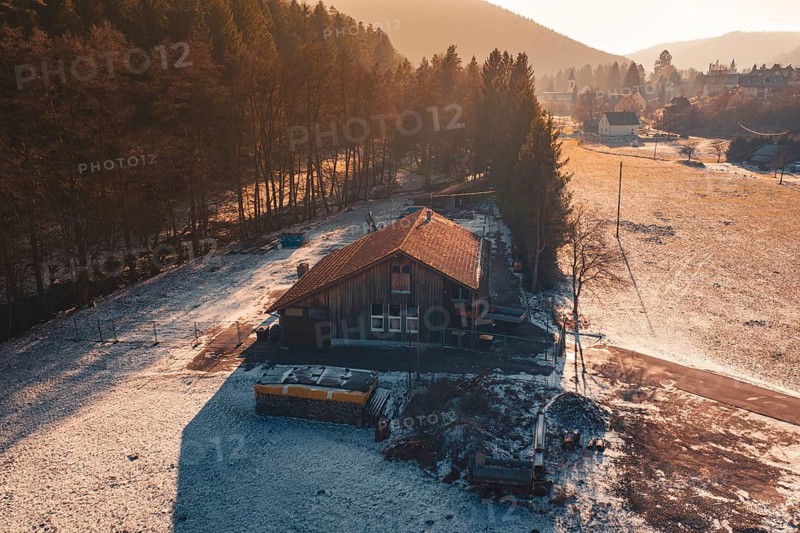 Wooden house on the edge of the forest, surrounded by snow, captured in the warm light of sunset light, Enzklösterle, Calw district, Germany