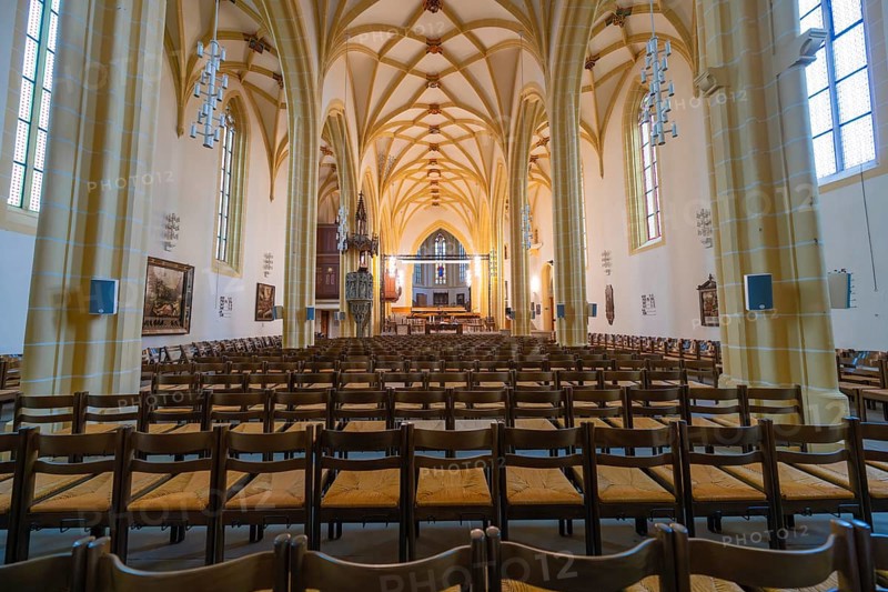 Extensive church space with Gothic vaults, wooden chairs and an altar in the center, collegiate church, Herrenberg, Böblingen district, Germany