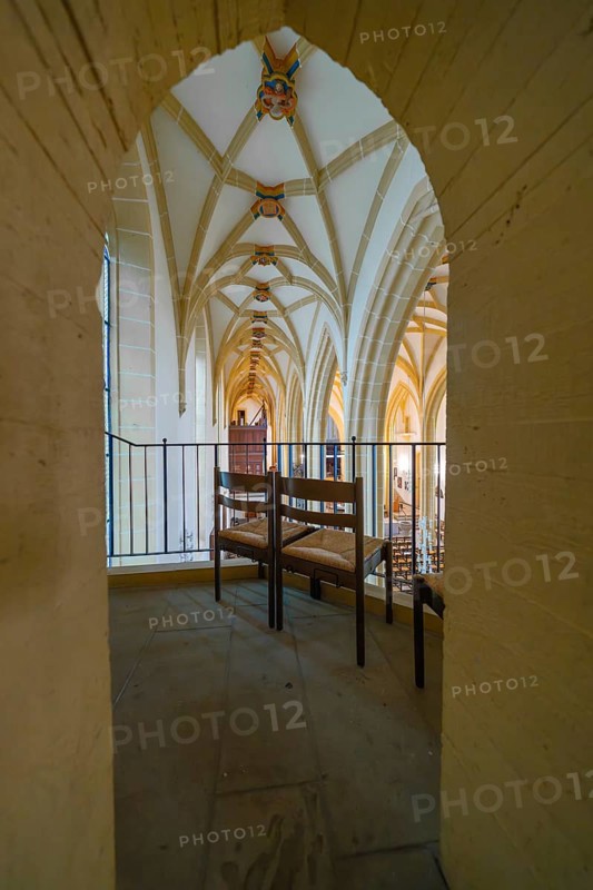 View through an arch of seats in a church with Gothic arches, quiet atmosphere, collegiate church, Herrenberg, Böblingen district, Germany