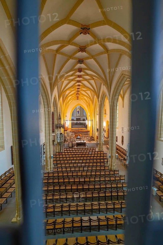 Symmetrical view of a church interior with altar and chairs, characterized by Gothic style, collegiate church, Herrenberg, Böblingen district, Germany