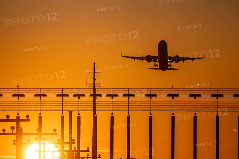 Runway lighting, approach aids, at Düsseldorf International airport, sunset, aviator taking off, in the background aircraft landing on the main runway south, 05R/23L, North Rhine-Westphalia, Germany