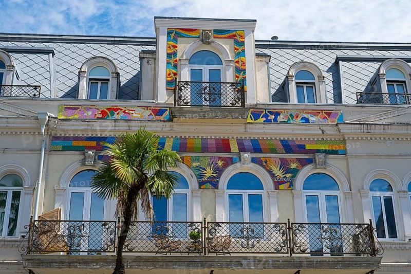 Detailed view of a building with colorful ornaments and palm trees in front of the balcony, Europe Square, Batumi, Black Sea, Adjara region, Adjara, Autonomous Republic, Georgia