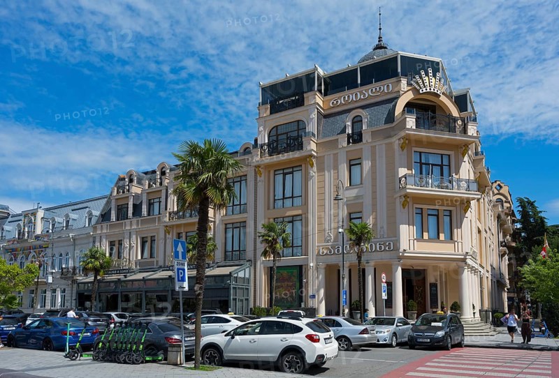 Elegant building with decorated facades and palm trees in front of a parking lot, Royal Casino and Hotel, Europe Square, Batumi, Black Sea, Ajara region, Adjara, Autonomous Republic, Georgia